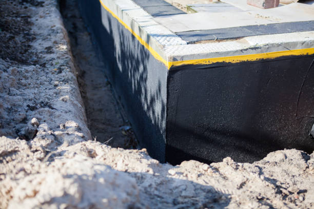 Professional Basement Waterproofing technician working in Taylorsville, IN